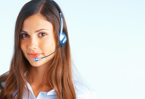 Young beautiful woman with headset on light blue background