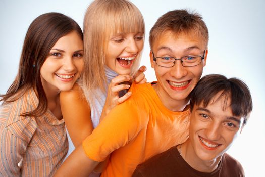 Young friends laughing together standing in a row
