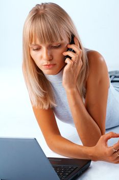 woman with laptop talking on the mobile