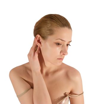 young woman putting make up on her face. Isolated