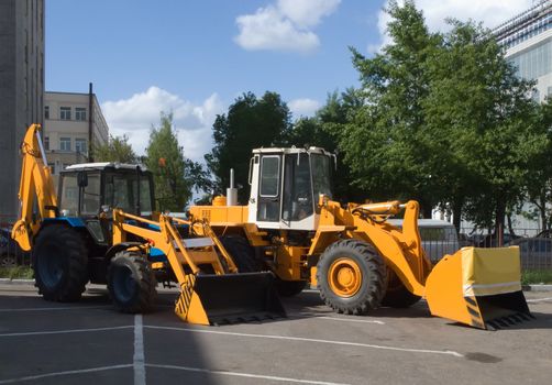 two bulldozer on asphalt road