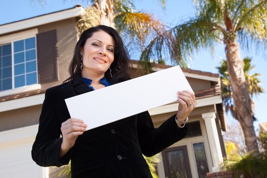 Happy Attractive Hispanic Woman Holding Blank Sign in Front of House.