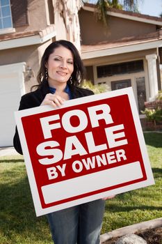 Happy Attractive Hispanic Woman Holding For Sale By Owner Real Estate Sign In Front of House.