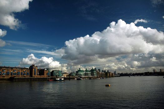 London river Thames with nice blue sky, white clouds and building