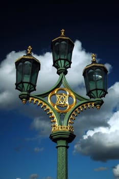 three street lights with blues sky and white cloud
