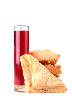 The red aerated drink in a high glass and rolls from the multilayered test.