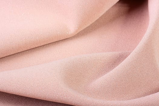 Background from a beige fabric which is used in a clothing industry.