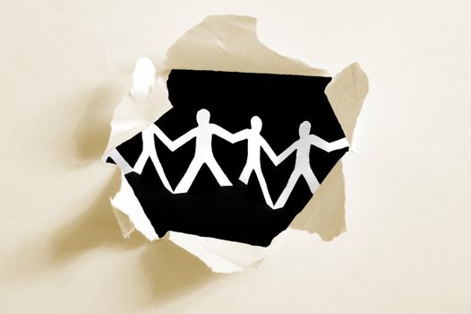 chain of paper man in a hole showing teamwork