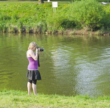 Teenage girl photographs by the river Severn