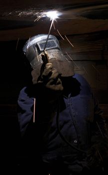 a welder working at shipyard at night