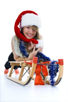 Beautiful  young woman on sledge on isolated background
