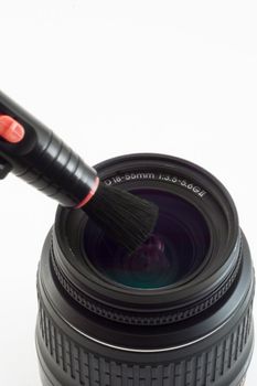 The object-glass with brush photographed on a white background