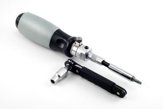 The screw-driver and wrench lay on a white background