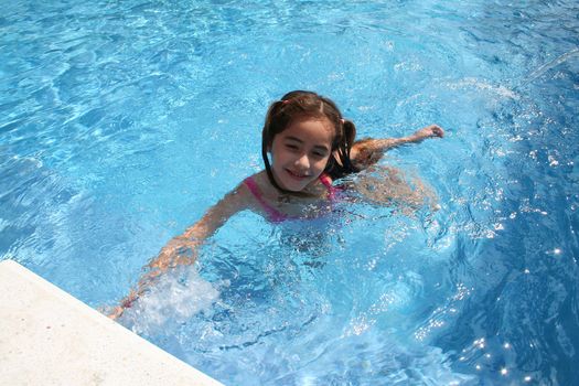 Young girl swimming in pool