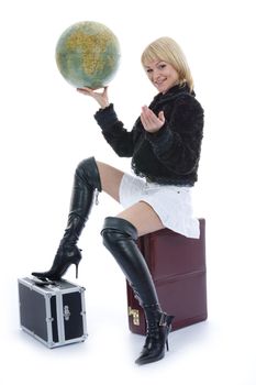 Beautiful blonde with valise and globe on isolated background