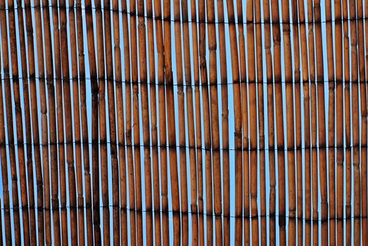 bamboo mat texture against a blue sky