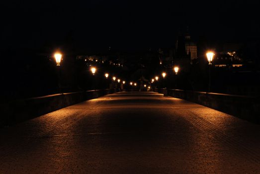 Charles bridge in Prague with lantern lights
