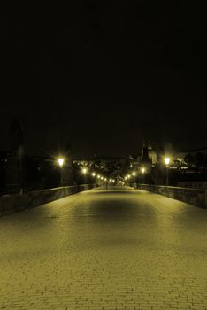 Charles bridge in Prague in the night shot in sepia
