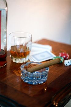 Scotch, cards, dice, and a cigar.