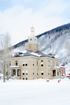 Old town hall in mountains with lots of snow