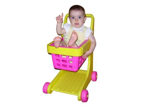 A little girl sitting in a toy shopping cart