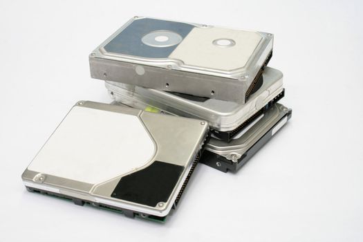 bunch of computer hard disks isolated on white background
