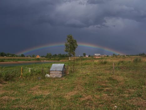Countryside. The rain approaches. A rainbow