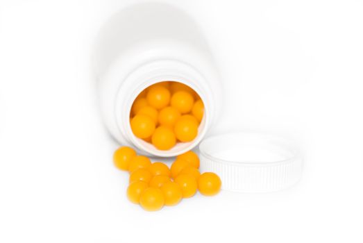 Yellow round vitamins were scattered from vial .
