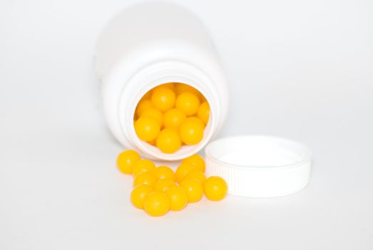 Yellow round vitamins were scattered from vial .