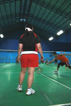 badminton  doubles match with male and female partners
