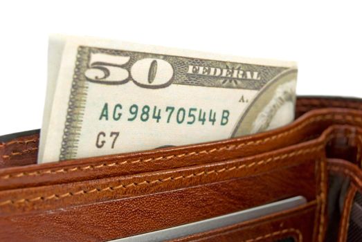 The brown purse with money is photographed  a close-up