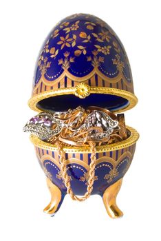 Gold ornaments are photographed in a casket in the form of egg