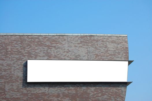 white empty billboard with copyspace for text and brickwall