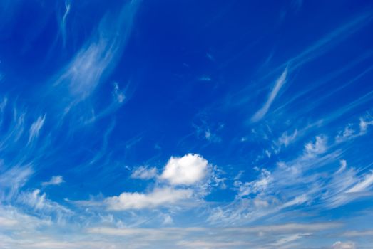 White clouds are photographed on a background of the blue sky