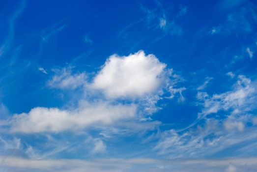 White clouds are photographed on a background of the blue sky