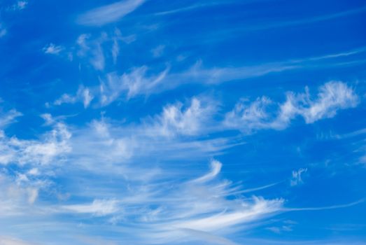 White clouds are photographed on a background of the blue sky