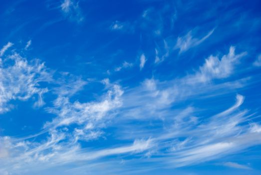 White clouds are photographed on a background of the blue sky