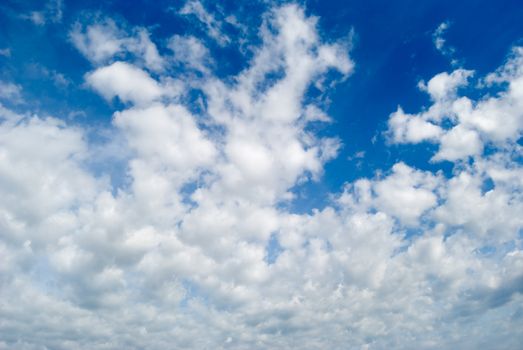 White clouds are photographed on a background of the blue sky