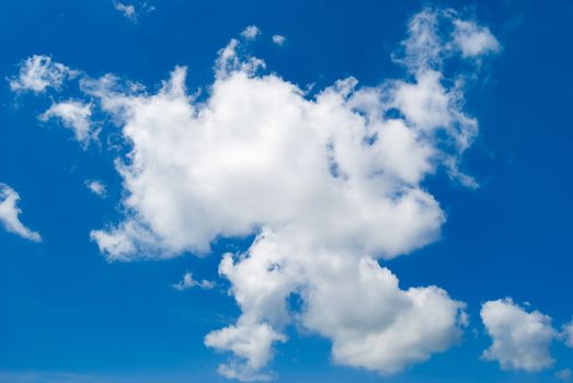 White clouds are photographed on a background of the blue sky