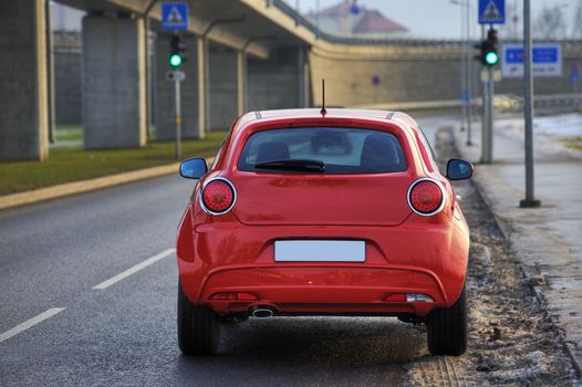 Red car view from rear, near the bridge, Riga, Latvia