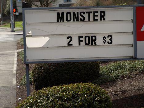 A sign advertises an apparent abundance of monsters, selling them two for $3.