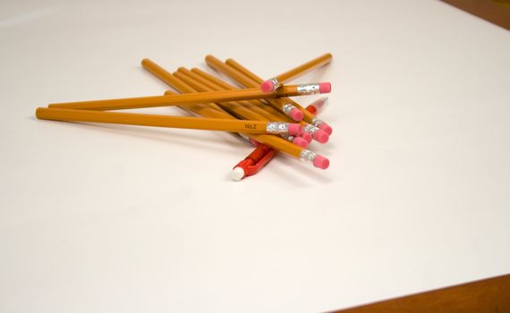 Outnumbered v1 or Dogpile or One versus Many or Old versus new is a gang of standard number two pencils piling onto a red mechanical pencil
