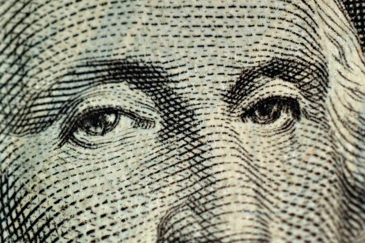 Macro of dollar bill featuring the eyes of George Washington