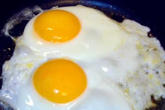 Eggs frying in open pan