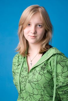 The young girl in green clothes on a dark blue background.