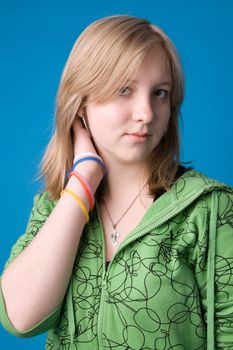 The young girl in green clothes on a dark blue background.