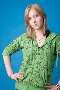 The young girl in green clothes on a dark blue background.