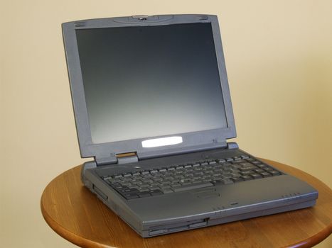 Typical notebook with silver screen. Computer on a table.