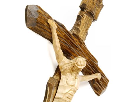 Wooden carved cross with crucified Jesus Christ. Religious symbol of catholic beliefs. Artistic icon.