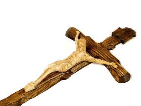 Wooden carved cross with crucified Jesus Christ. Religious symbol of catholic beliefs. Artistic icon.